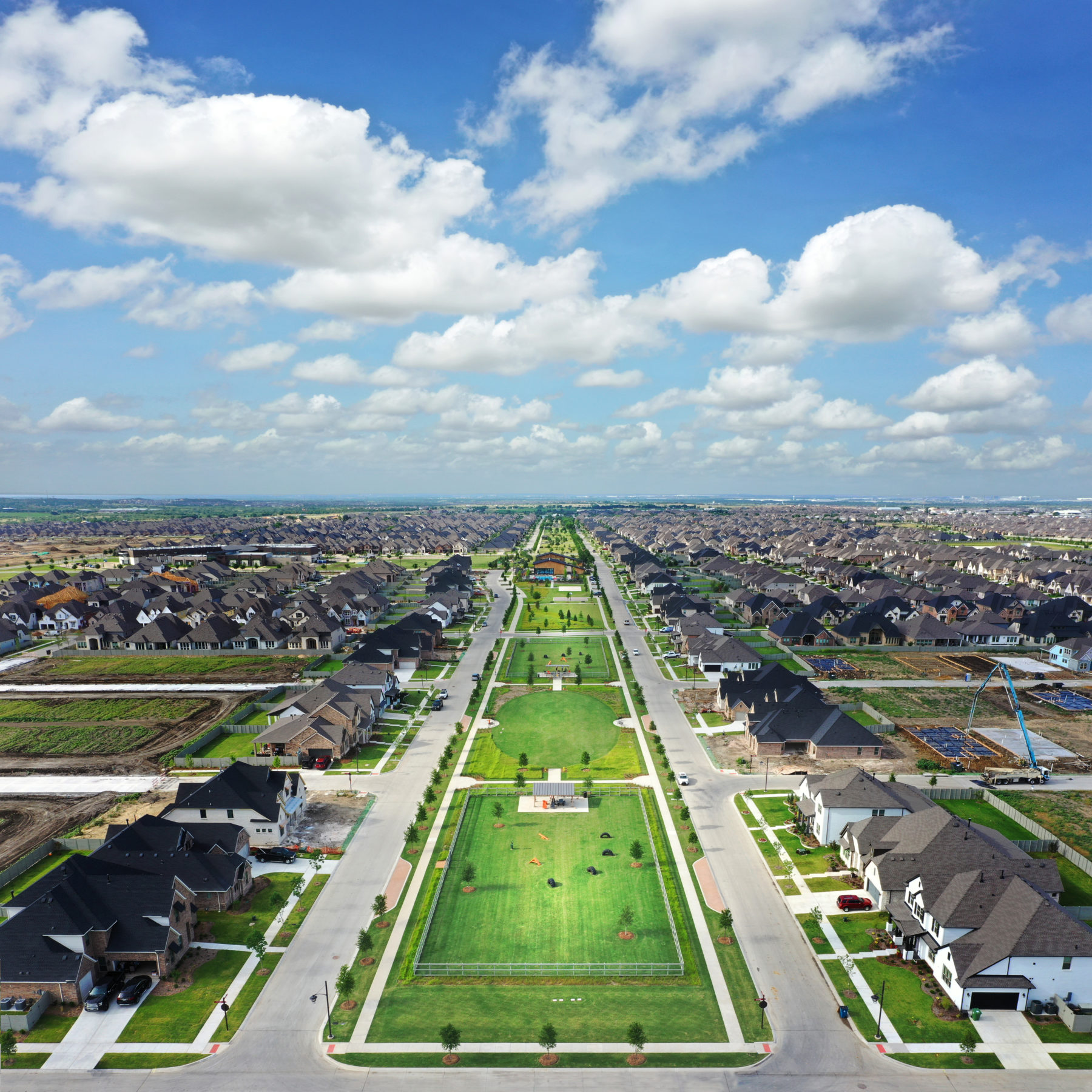 A bird's eye view of Harvest, with beautiful homes and a green grass parkway