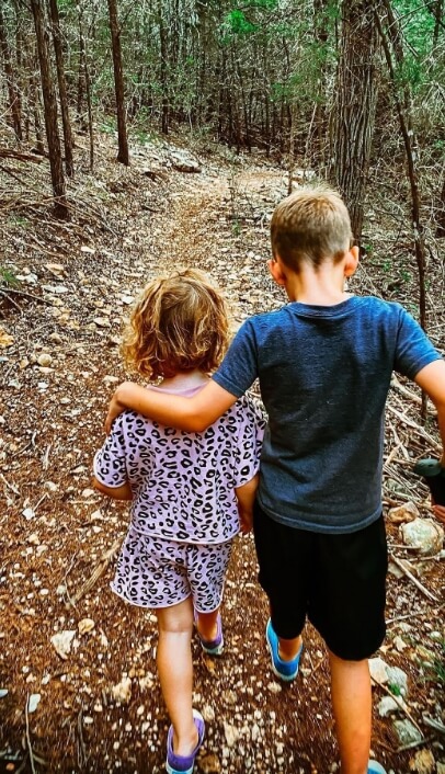 A little boy and is little sister walking along a trail at a Lifestyle by Hillwood community