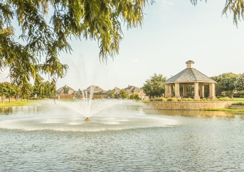 The lake with fountain at Liberty with a gazebo in the background.