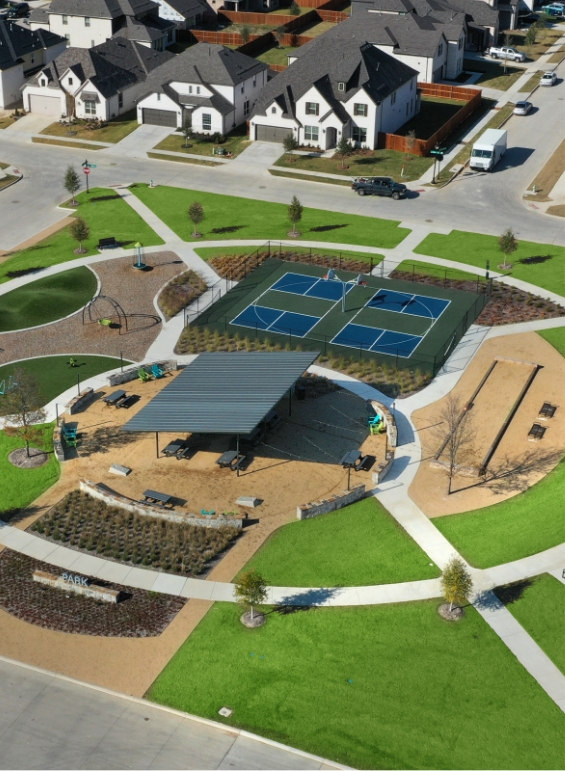 A bird's eye view of the shade structure and pickleball courts at Lilyana