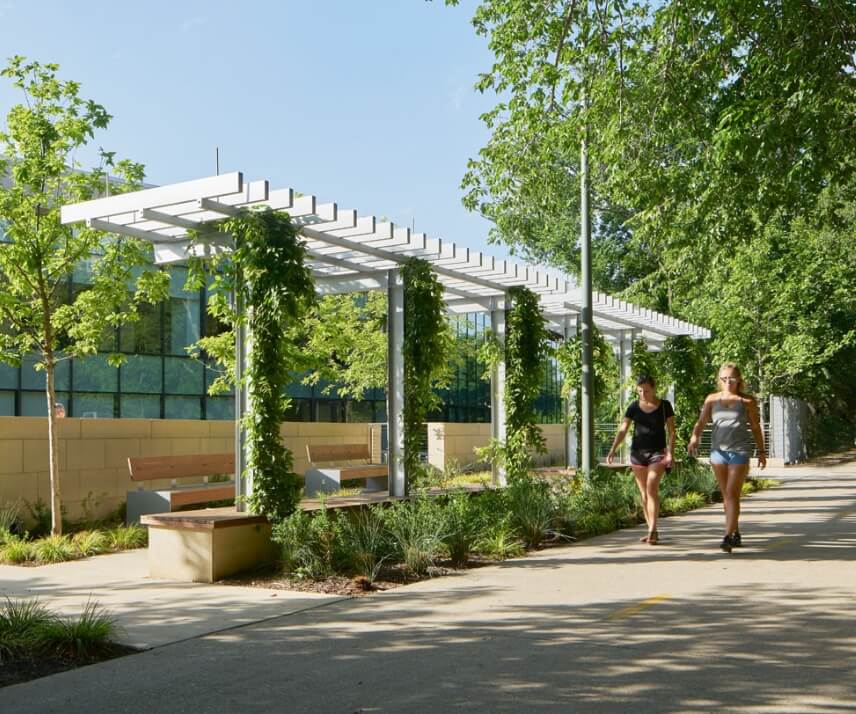 Two women walking along a paved trail in one of the Lifestyle by Hillwood communities in North Texas.