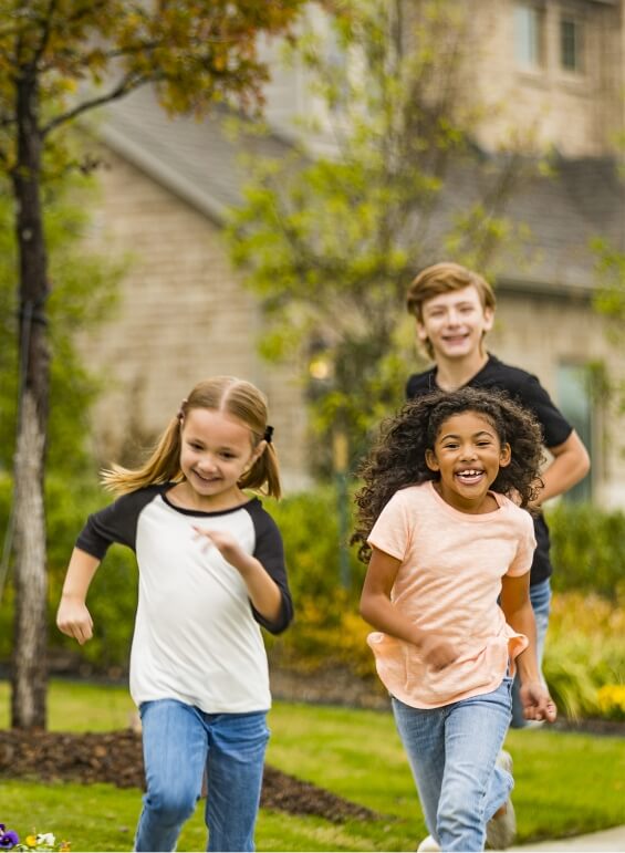 Three kids playing in their neighborhood in Bluewood