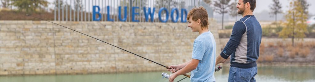 A son and his father fishing at the lake at Bluewood