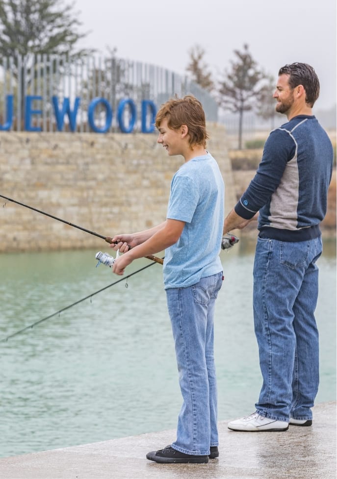 A son and his father fishing at the lake at Bluewood