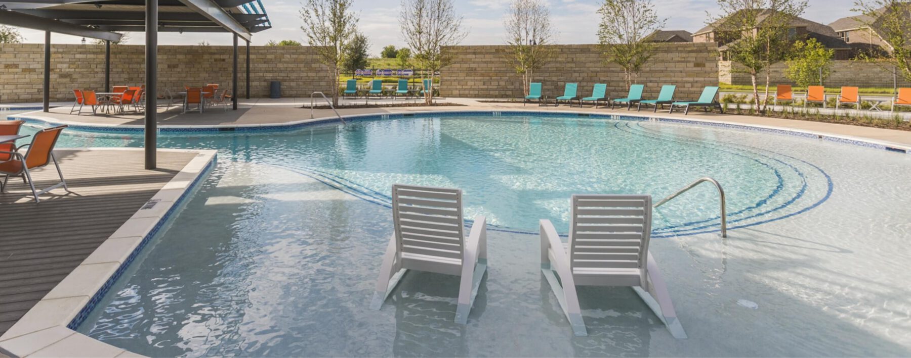 Two chairs sitting on the entry to the pool at Bluewood