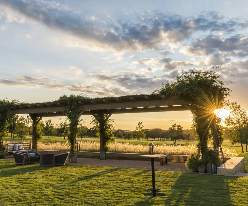 The outdoor pergola looking out over the sunset at the Hillwood headquarters in Dallas, Texas