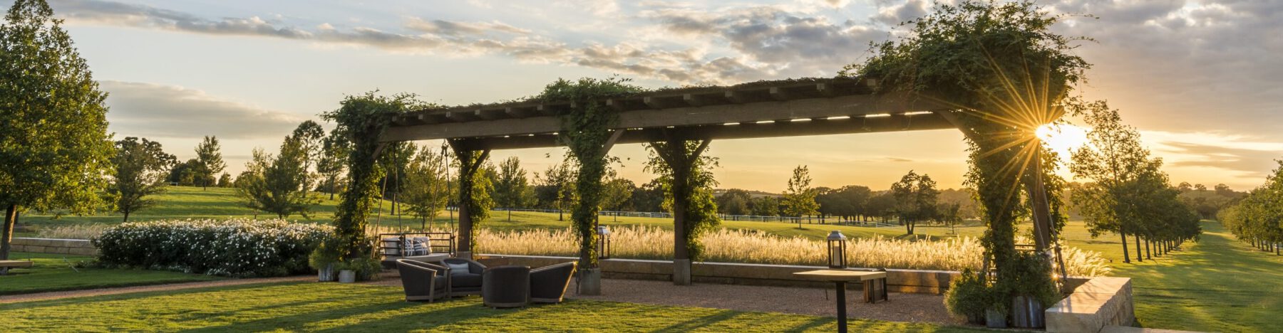 The outdoor pergola looking out over the sunset at the Hillwood headquarters in Dallas, Texas