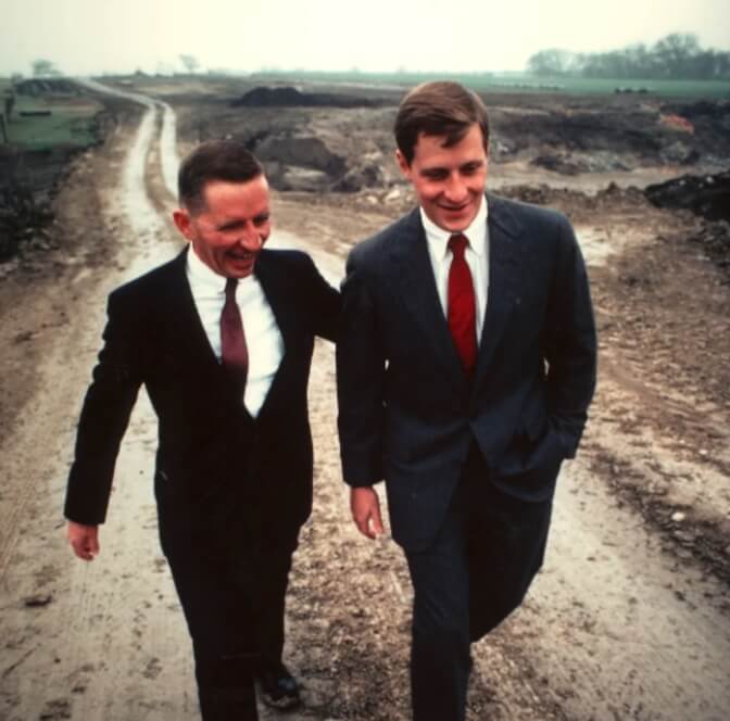 A young Ross Perot, Jr. walking along a dirt road with his father, Ross Perot, Sr.