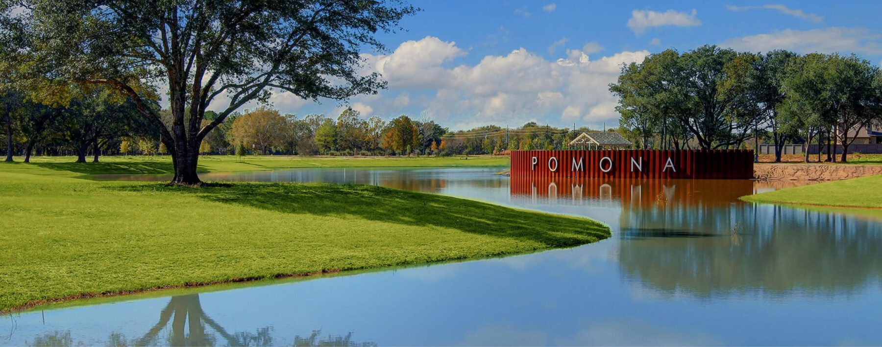 The lake with trees and Pomona sign in the background