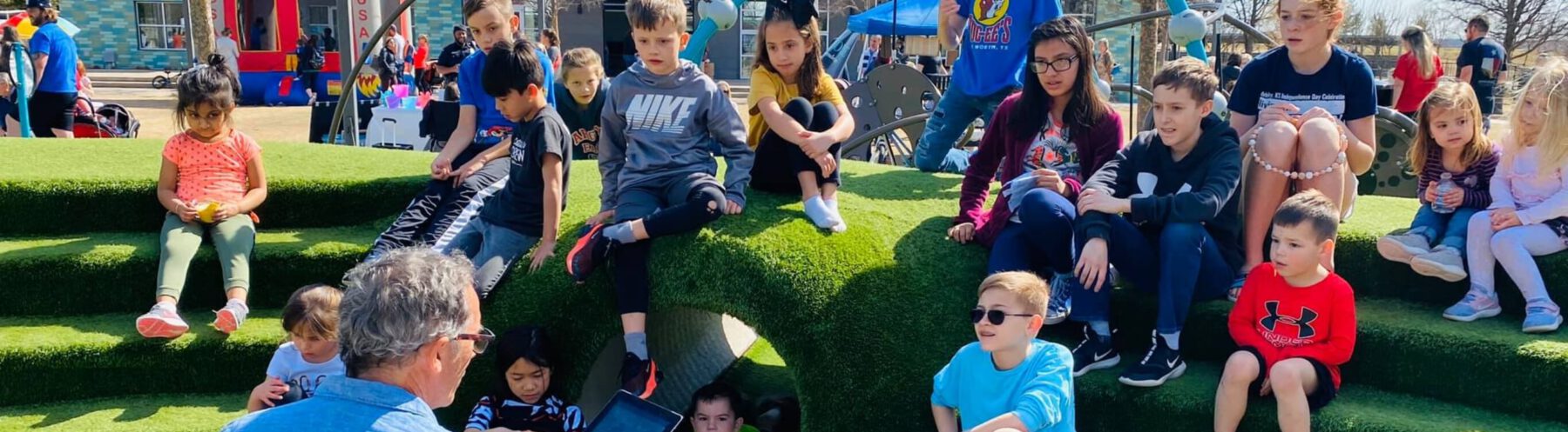 Kids listening to instructions for a game while at a local park in a Lifestyle by Hillwood community