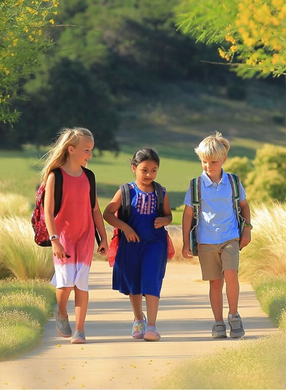 Three kids walking to their local school at Wolf Ranch