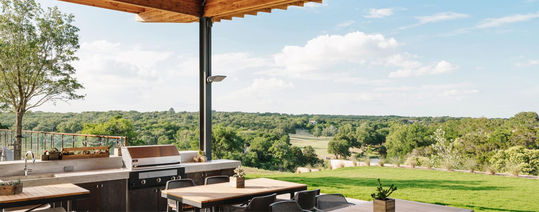 The outdoor grilling area at Wolf Ranch which looks out over the groves of trees.