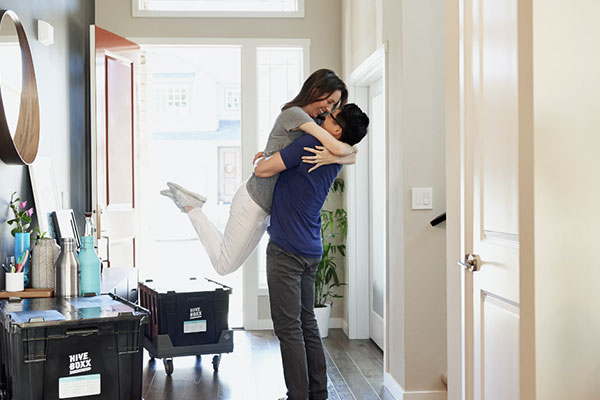 A couple embracing to celebrate moving into their new home