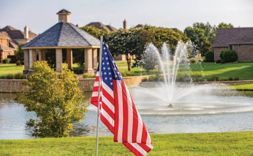 The American flag with the Liberty lake fountain in the background