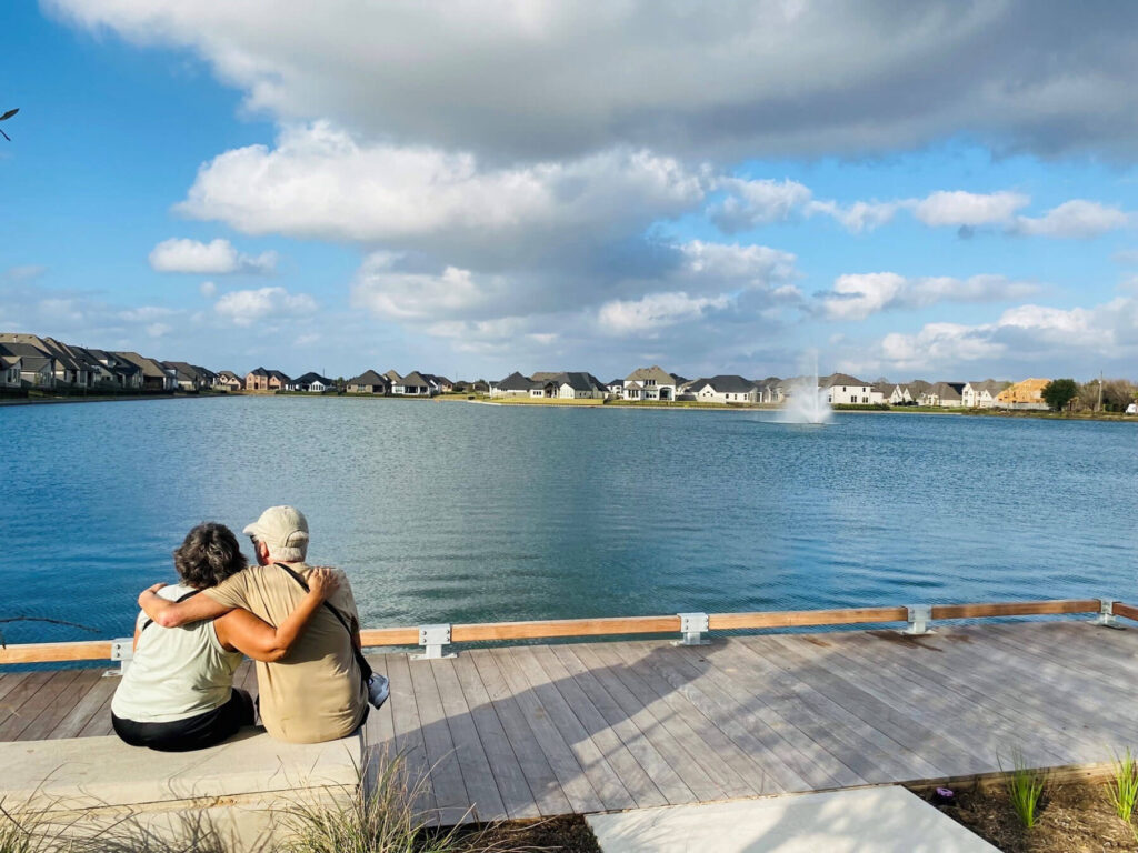 A 55+ couple sitting by the lake at Liberty