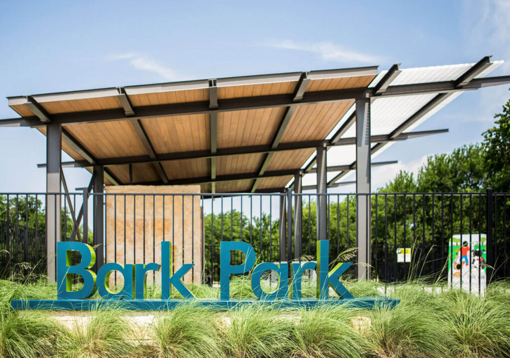 The Bark Park sign and shade structure in the background
