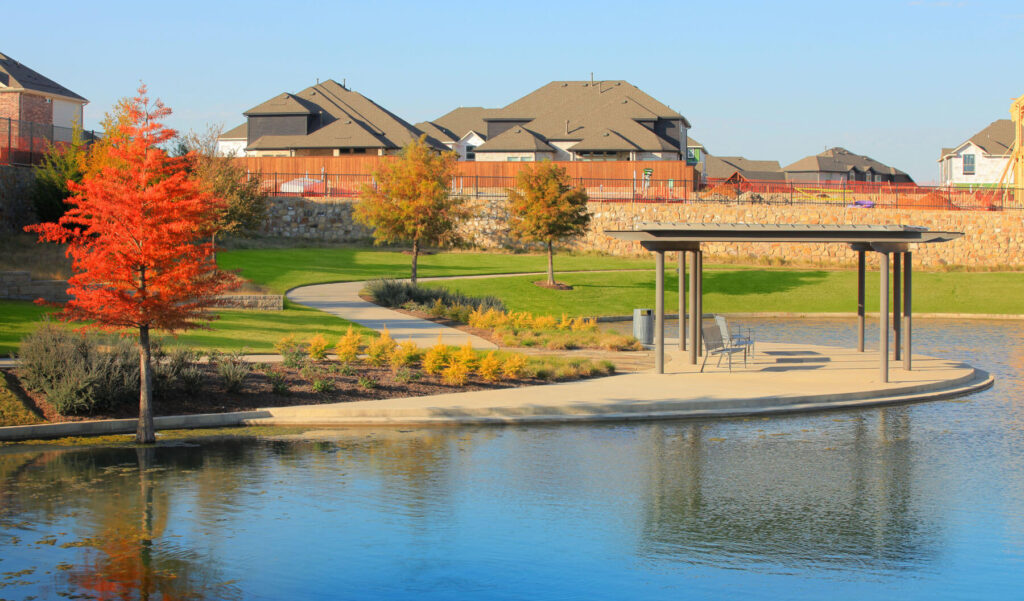 A shade structure by the lake at a Lifestyle by Hillwood community