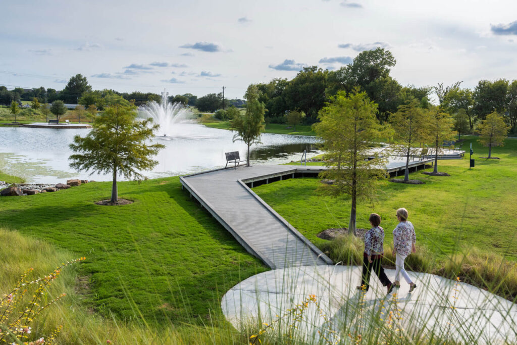 Two women walking along the dock at the lake