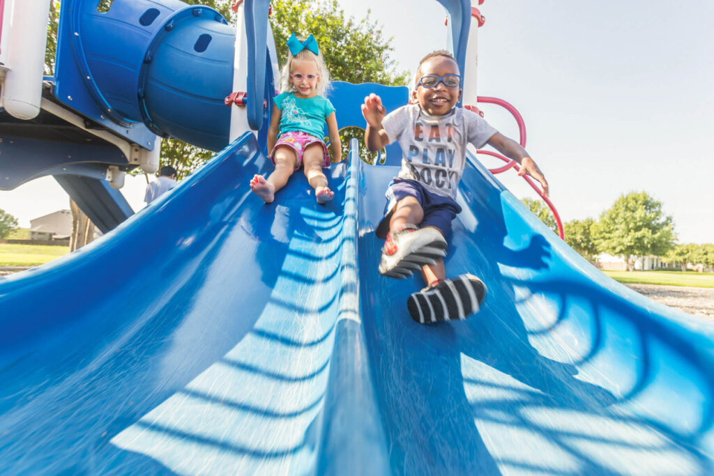 Two kids enjoying the slides at Liberty