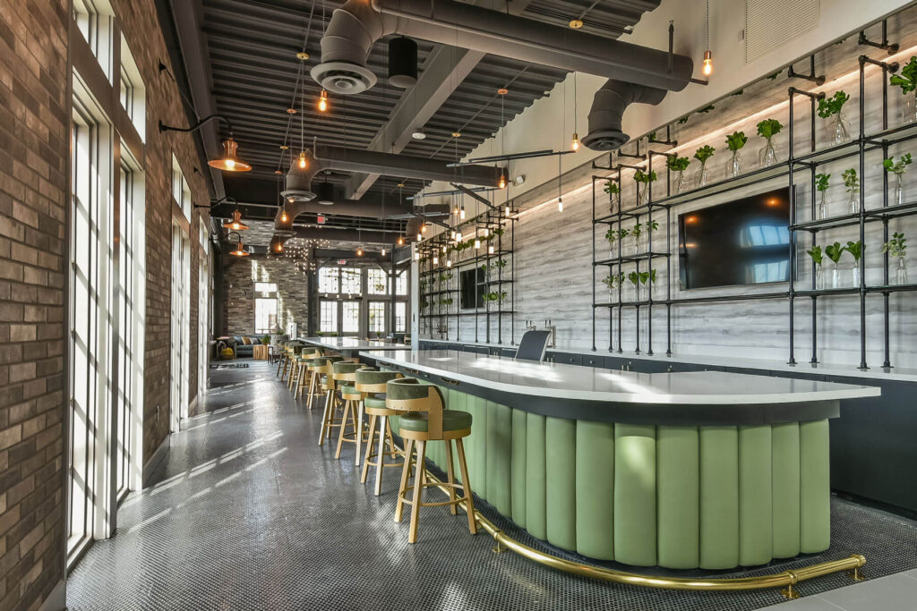 A seating area with green bar and wall plantings