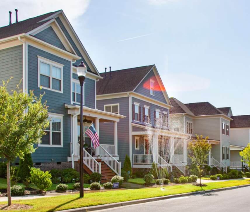 A streescape with beautiful homes and green trees at a Lifestyle by Hillwood communities
