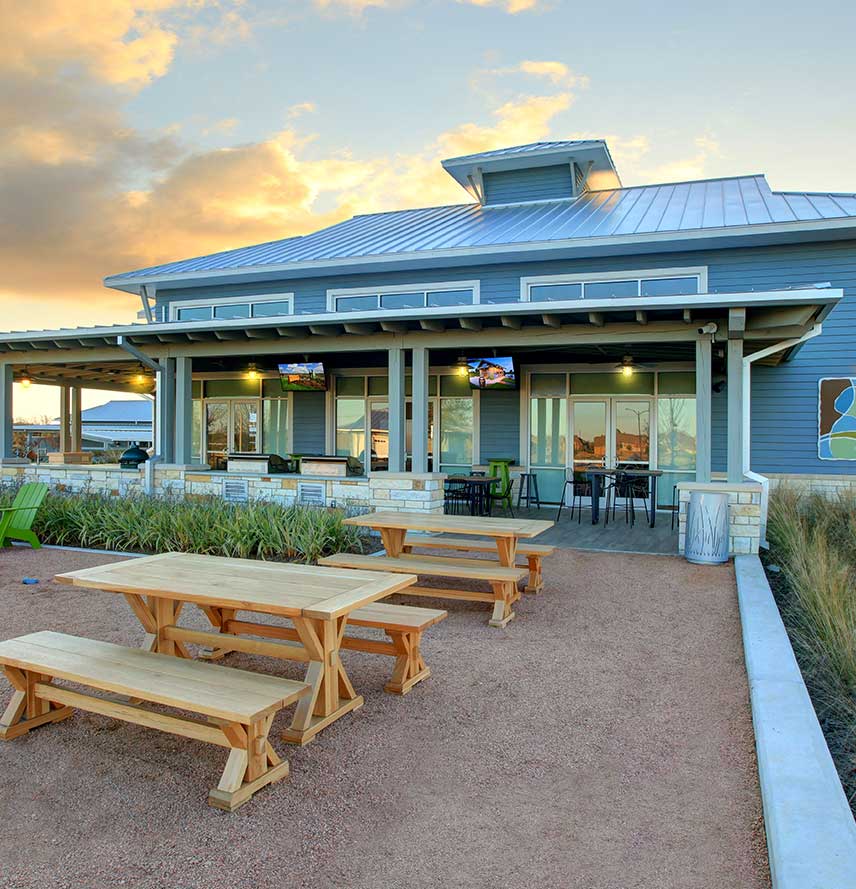 A blue communal building that serves as the "Camp" at Pomona by Hillwood