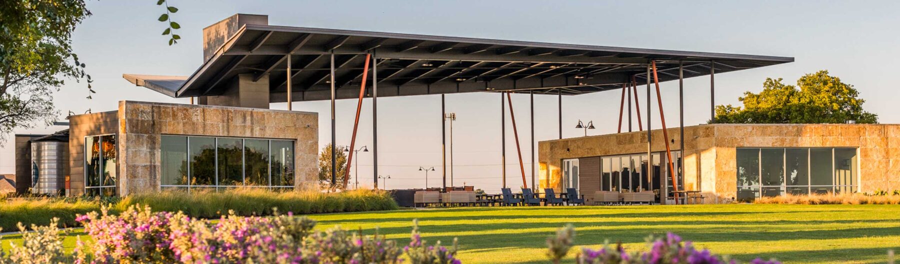 A covered pavilion with landscaping in the foreground