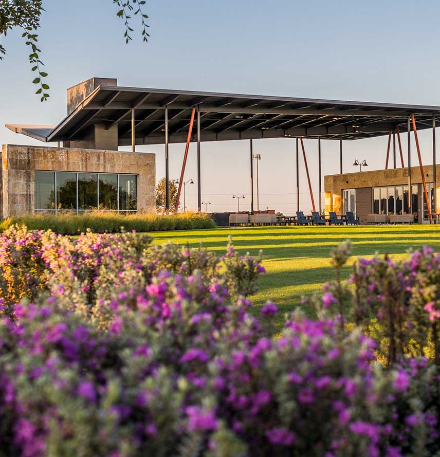 A covered pavilion with landscaping in the foreground